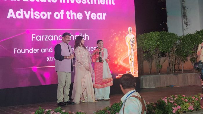 Farzana Shaikh receiving the Real Estate Investment Advisor of the Year award on stage